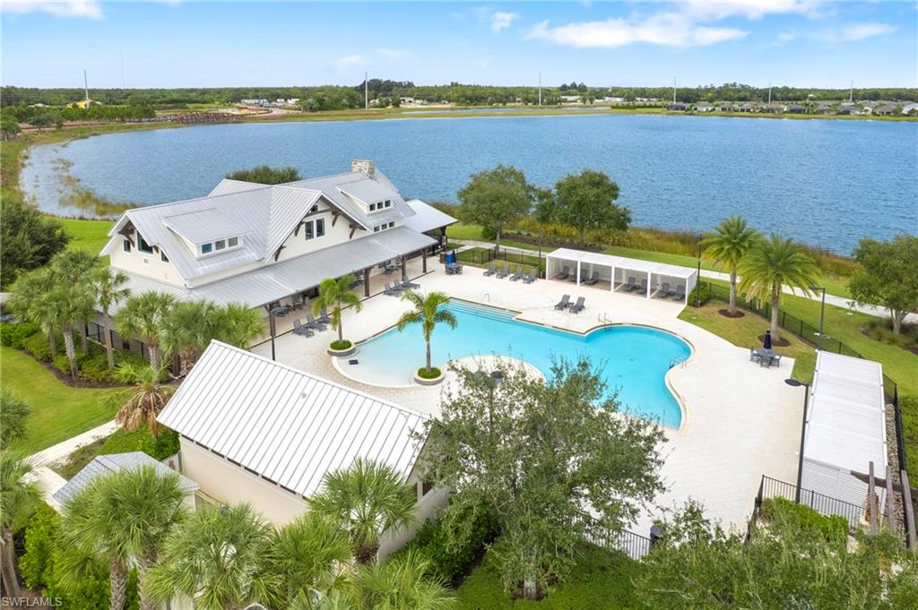 Expansive resort-style pool area featuring a free-form swimming pool, multiple shaded cabanas, and ample lounge space
