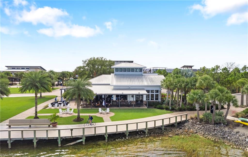 Waterfront building with a metal roof and a spacious outdoor patio