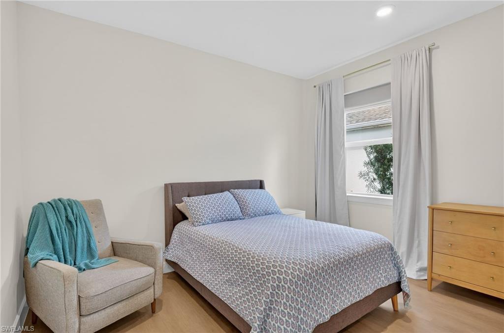 Light-filled room featuring wood-finish flooring, recessed lighting, and neutral wall tones