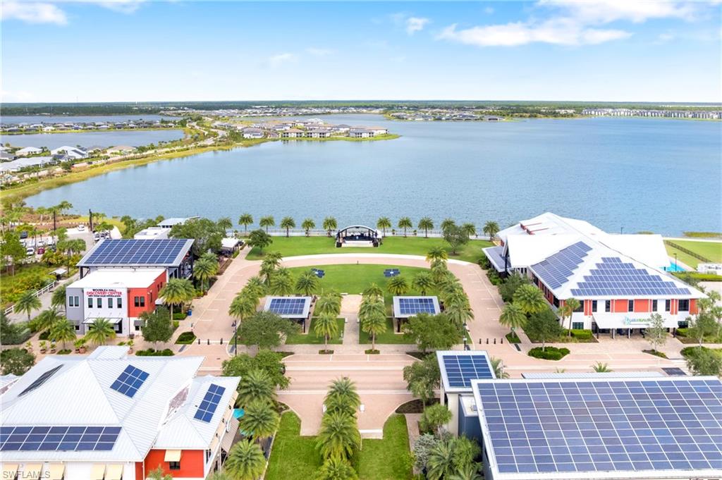 Aerial perspective highlighting a large central green space surrounded by commercial buildings, all featuring extensive rooftop solar panel installations