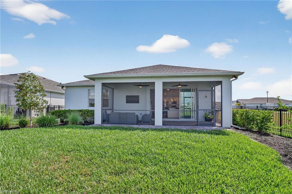 Expansive screened-in lanai with a ceiling fan, recessed lighting, and direct access to the interior