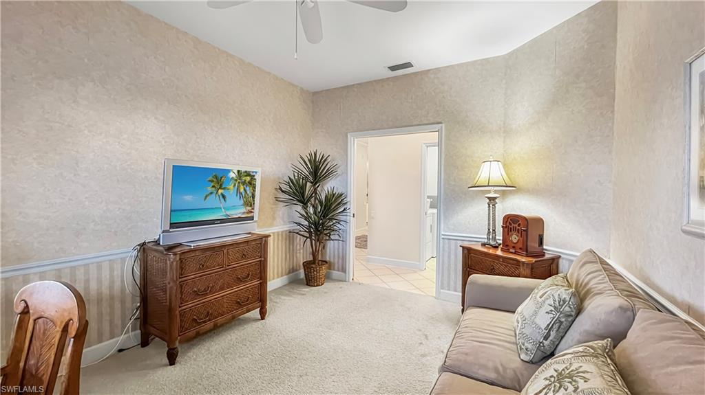Living room with light carpet and ceiling fan