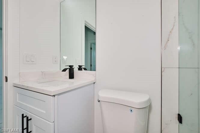 Full bath with vanity and a shower