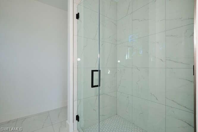 Bathroom with a marble finish shower