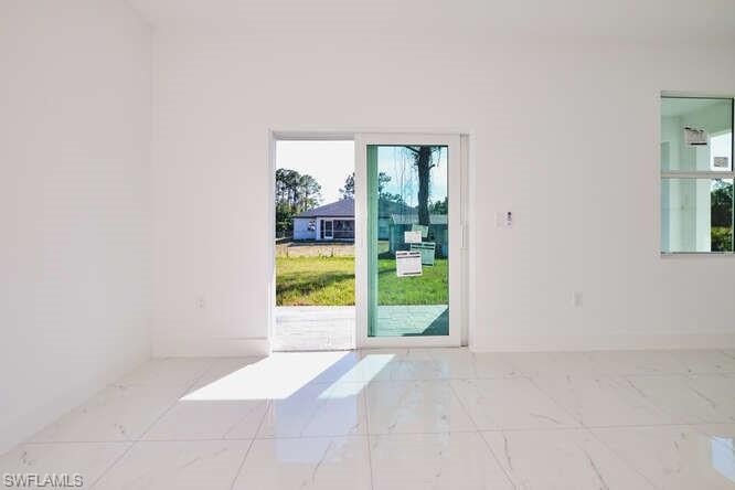 Spare room with plenty of natural light and light marble finish flooring