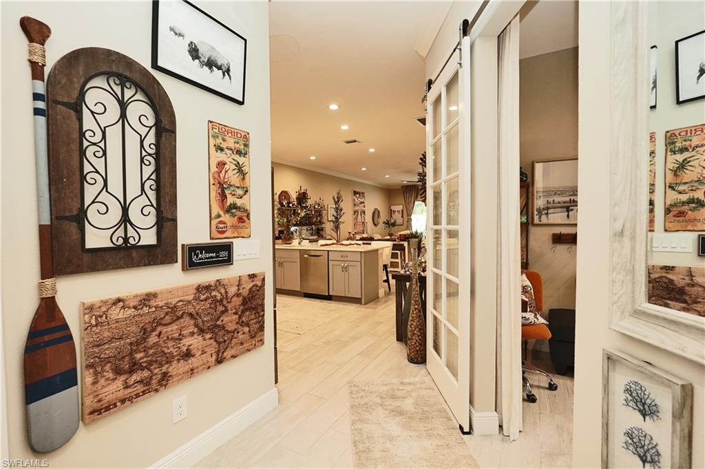from foyer - den with barndoor slider to kitchen and livingroom