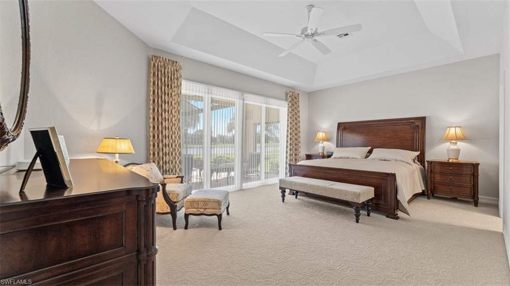 Spacious room featuring a tray ceiling, recessed lighting, and a ceiling fan