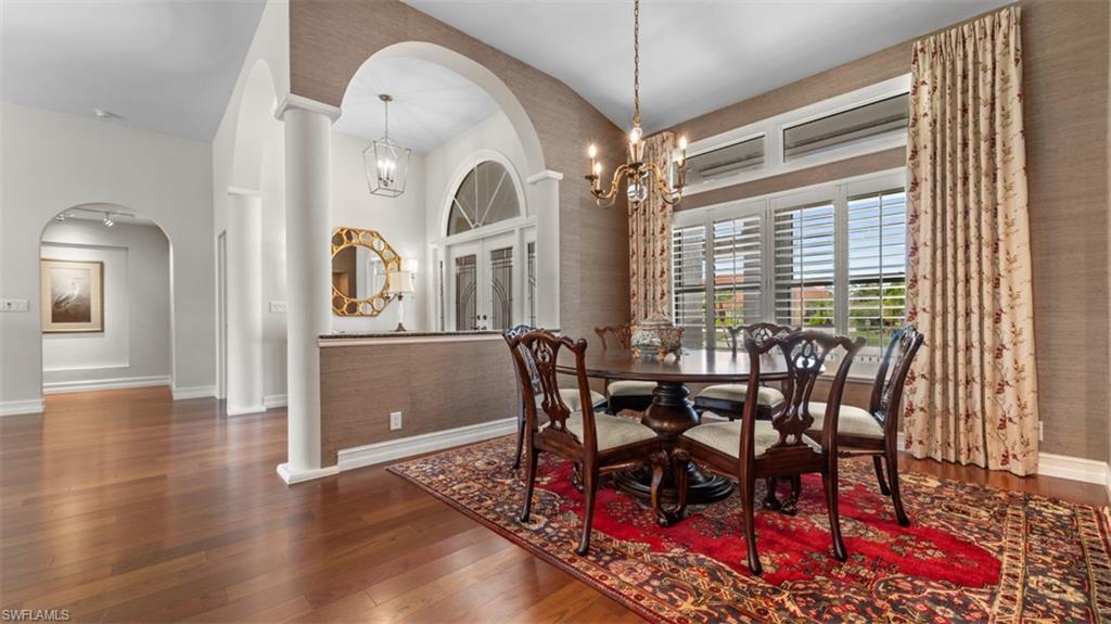 Formal dining area featuring hardwood flooring and textured wall covering