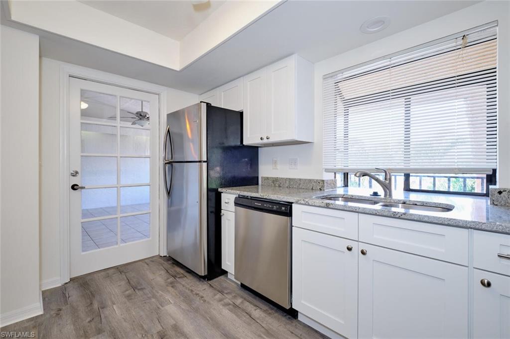 Kitchen featuring white cabinetry, granite countertops, and stainless steel appliances