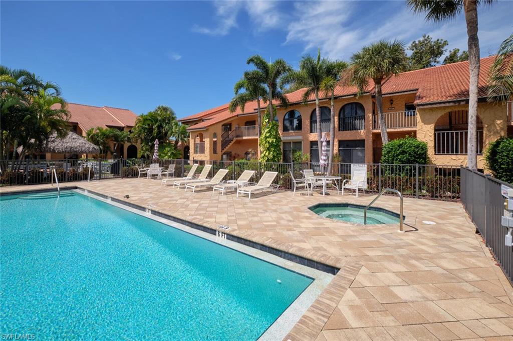 Outdoor swimming pool with integrated spa and paver surround