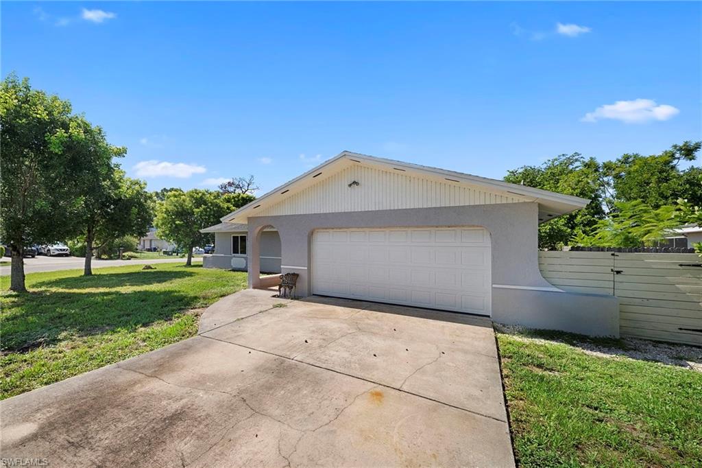 Single-story residence featuring a two-car garage, stucco exterior, and a concrete driveway