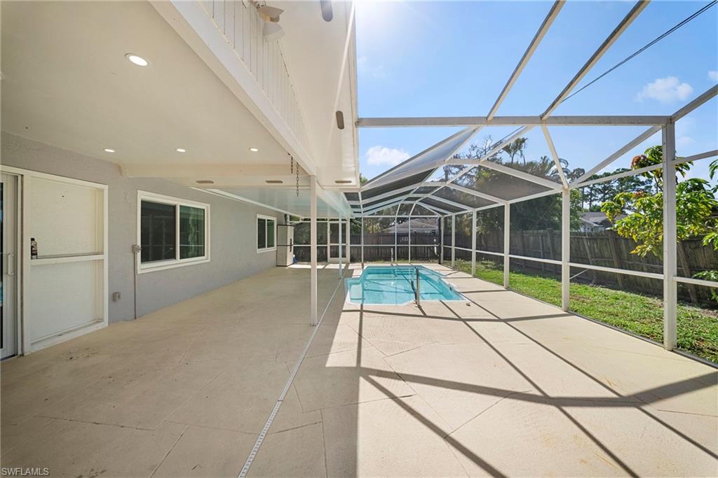 Screened enclosure with an in-ground pool and an expansive concrete patio