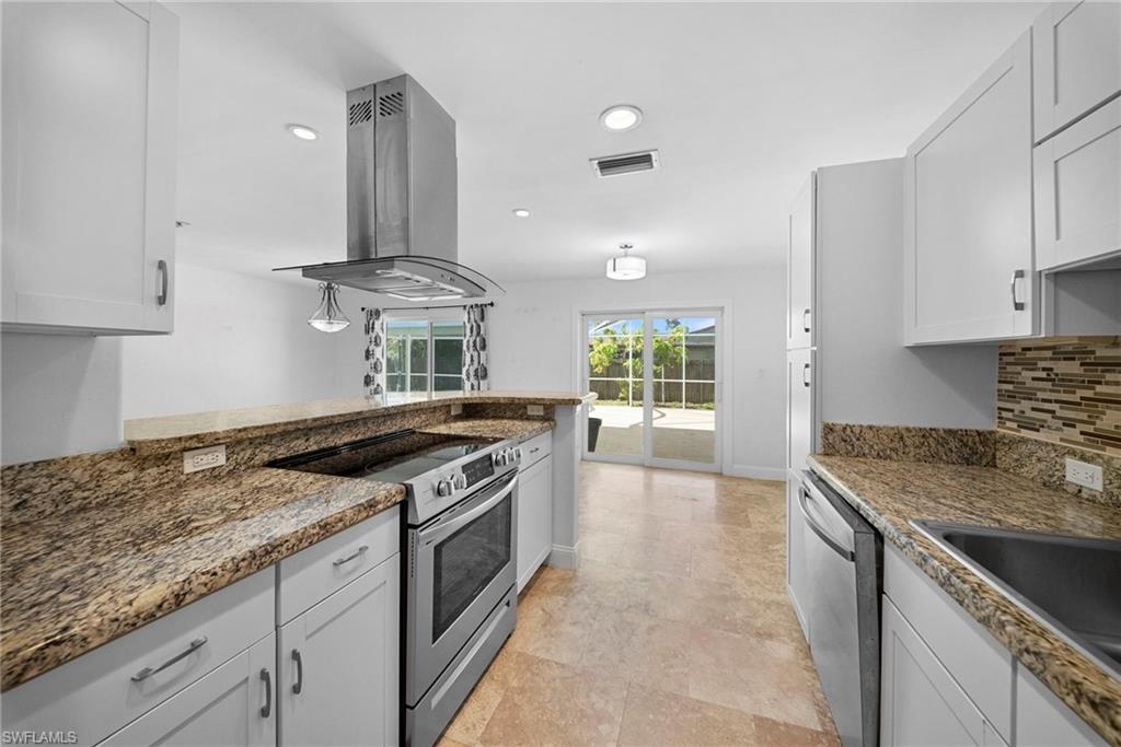 Kitchen featuring light cabinetry, stainless steel appliances, granite countertops, a tile backsplash, and tile flooring