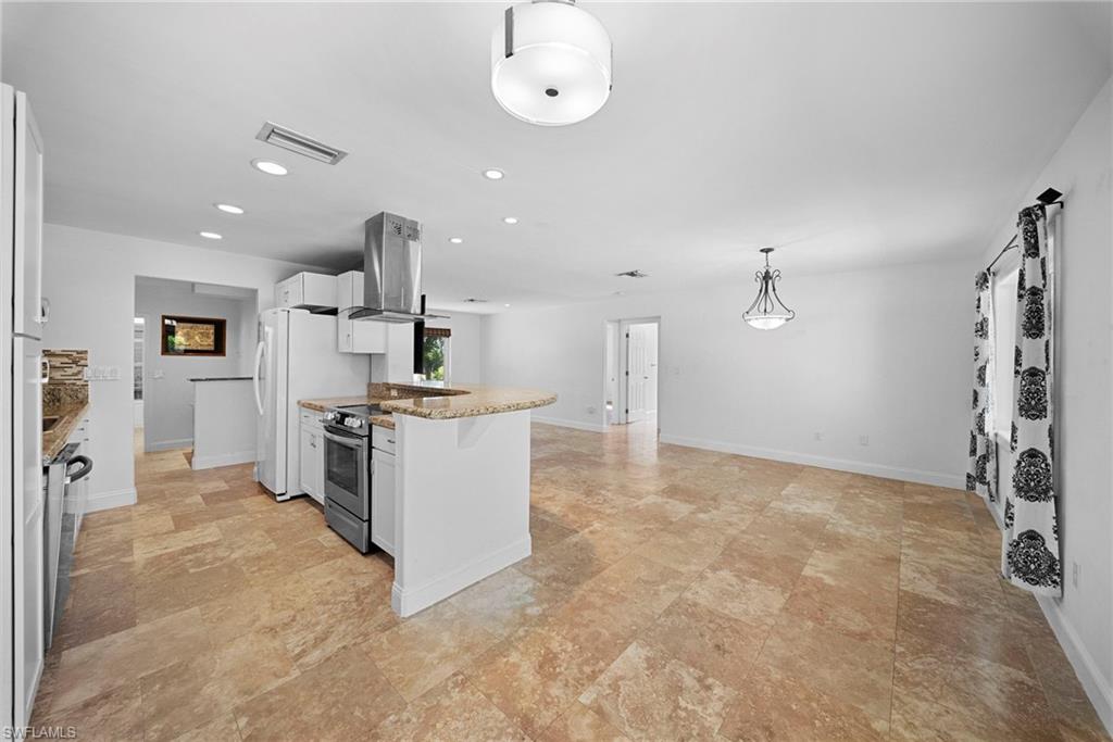 Open-concept living space featuring expansive tile flooring and recessed lighting