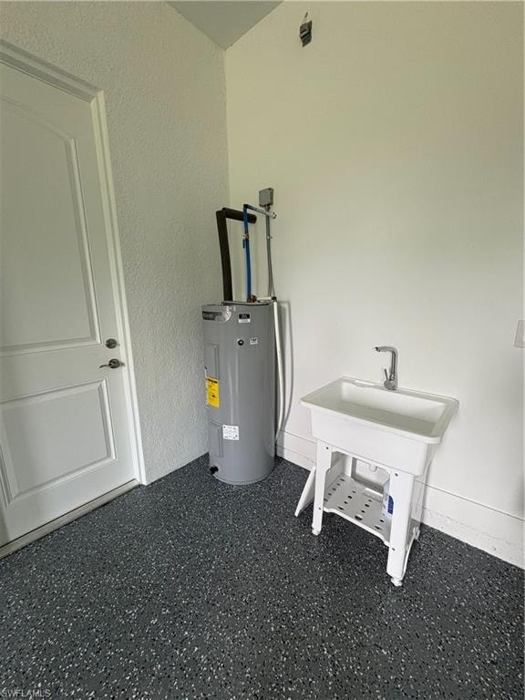 Utility space featuring a water heater, laundry sink with chrome faucet, and a white paneled door