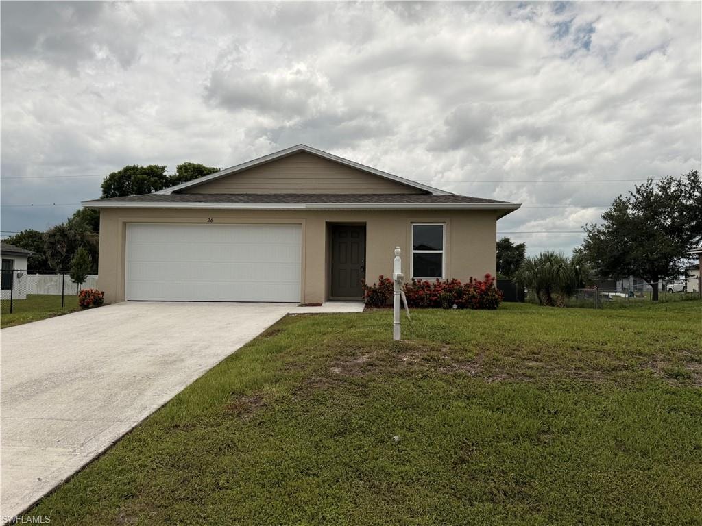 Front exterior with a concrete driveway, attached garage, covered entry, and shrub landscaping