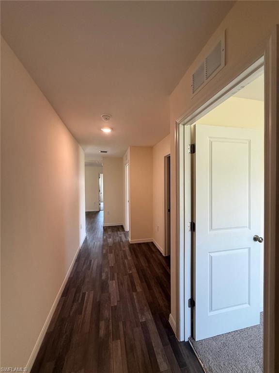 Interior hallway featuring wood-finish flooring, recessed lighting, and neutral wall paint