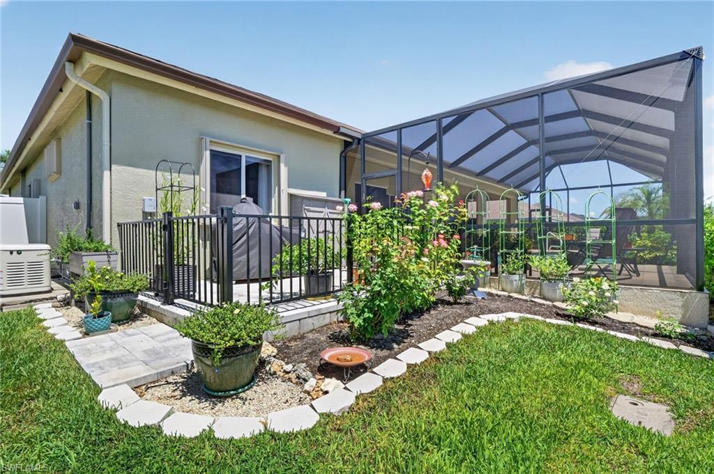 Additional outdoor paver patio with custom metal fence with gate