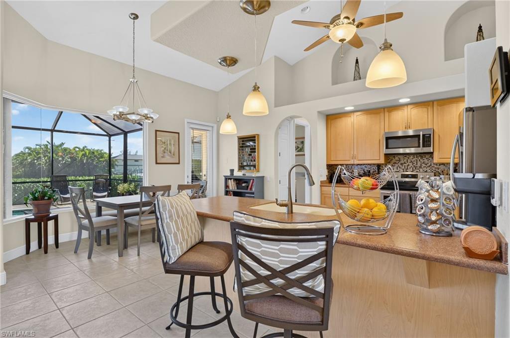 Dinning area off kitchen with pool and canal view