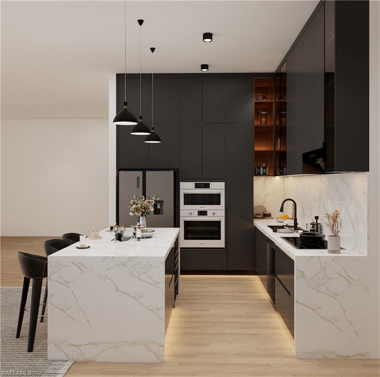 Contemporary kitchen featuring a waterfall island with integrated seating, dark flat-panel cabinetry, light wood-finish flooring, and white marble-patterned countertops and backsplash (Rendered photo)