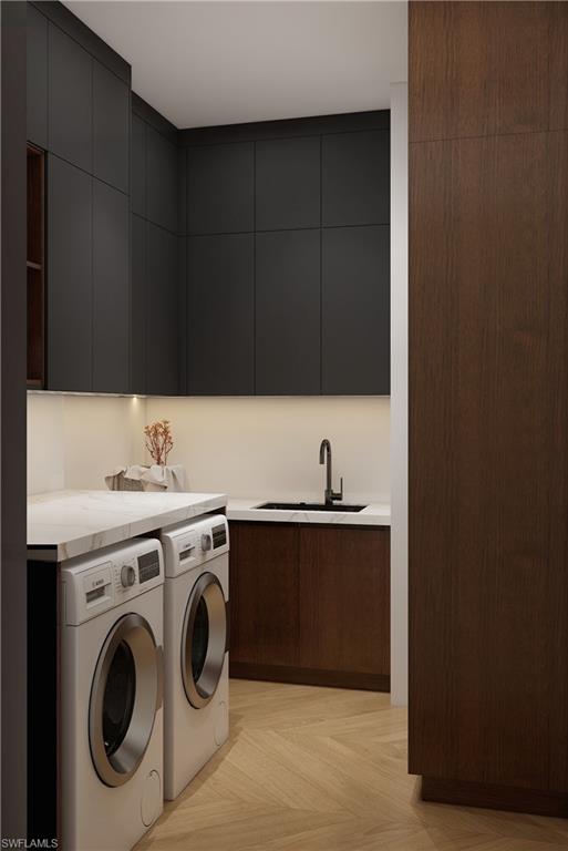 Dedicated laundry space featuring herringbone wood-finish flooring, dark cabinetry with integrated lighting, a built-in sink with a matte black faucet, and a light-colored countertop (Rendered photo)