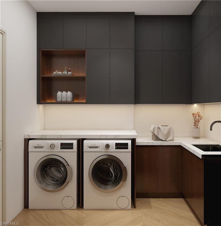 Laundry area featuring dark cabinetry, integrated shelving with accent lighting, under-cabinet lighting, a built-in sink, and light-toned countertops (Rendered photo)