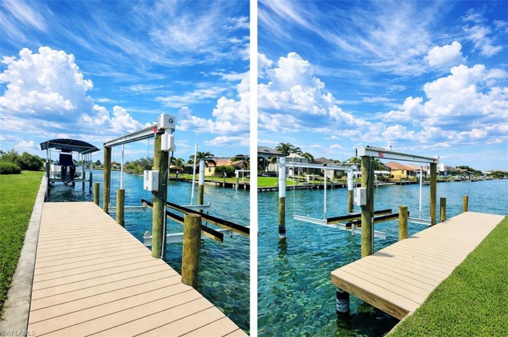 Waterfront property featuring two boat (Rendered photo)lifts, a covered boat slip, and direct water access