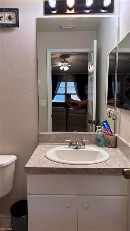 Bathroom vanity featuring a laminate countertop with an integrated white sink and chrome faucet