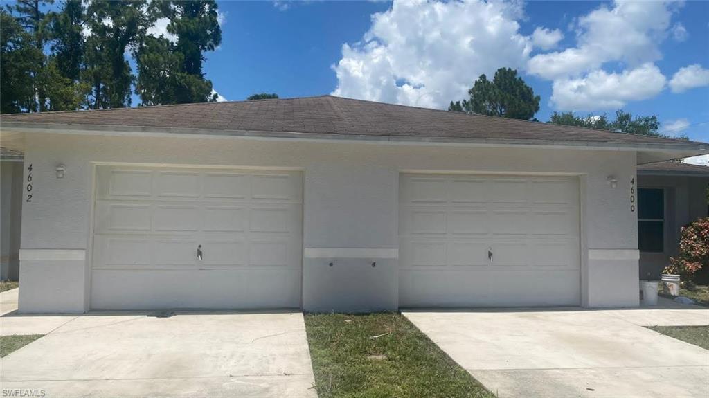 Two single-car garage doors with panel detailing