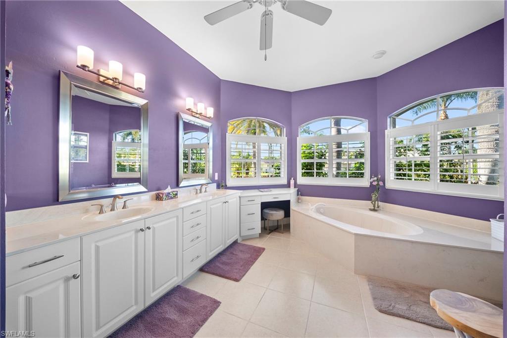 Dual vanities with white cabinetry and light-colored countertops