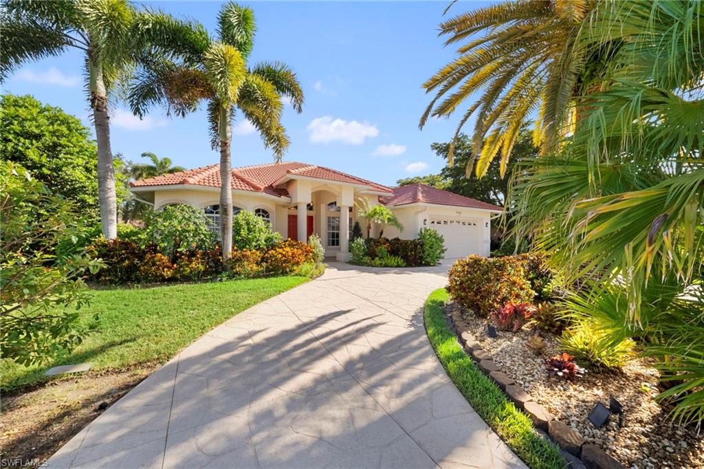 Mediterranean-style residence featuring a terracotta tile roof and stucco exterior