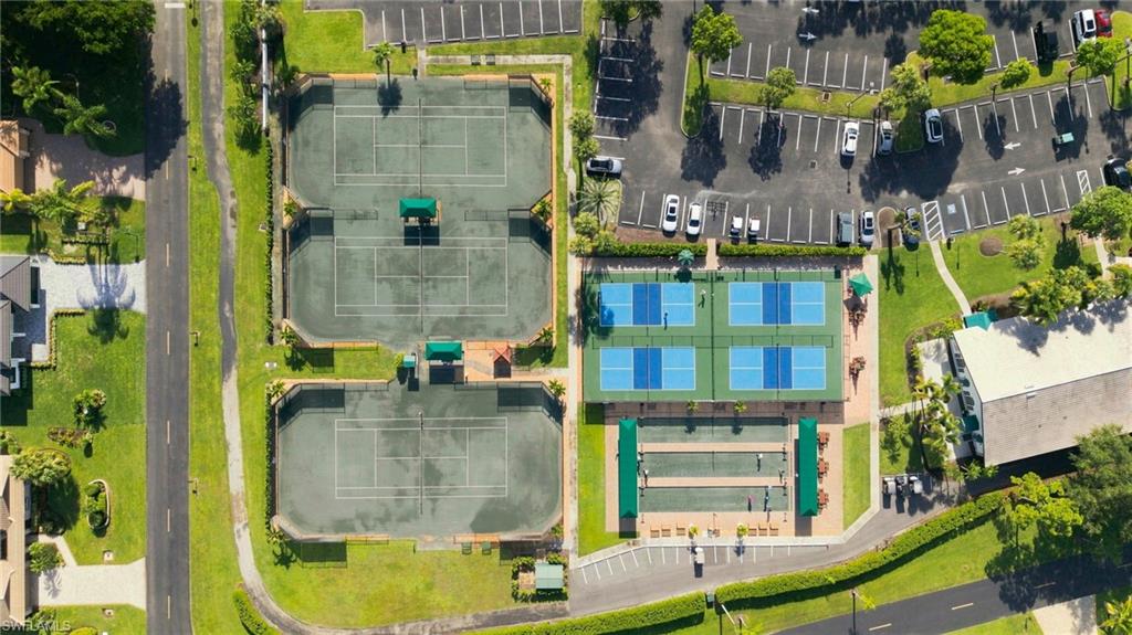 Multiple tennis courts, four pickleball courts, bocce ball courts, a parking area, and manicured green spaces