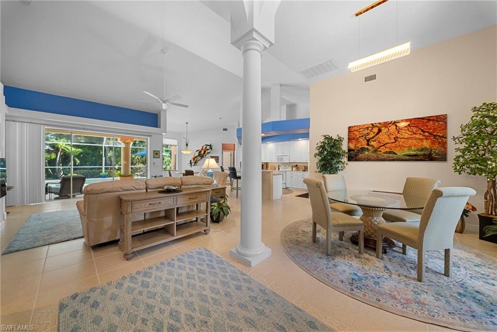 Tile flooring throughout, vaulted ceilings, and a decorative column