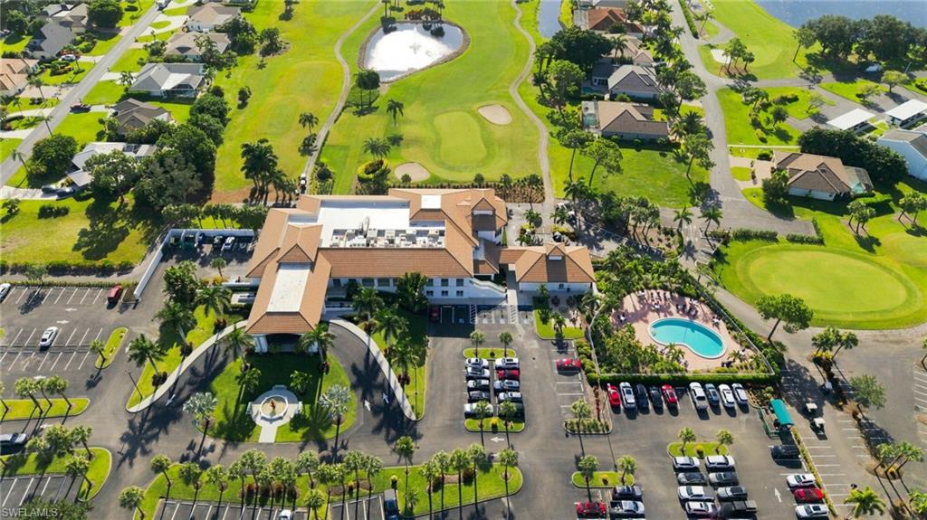 Extensive golf course, resort-style swimming pool, lush landscaping, central clubhouse, and ample parking