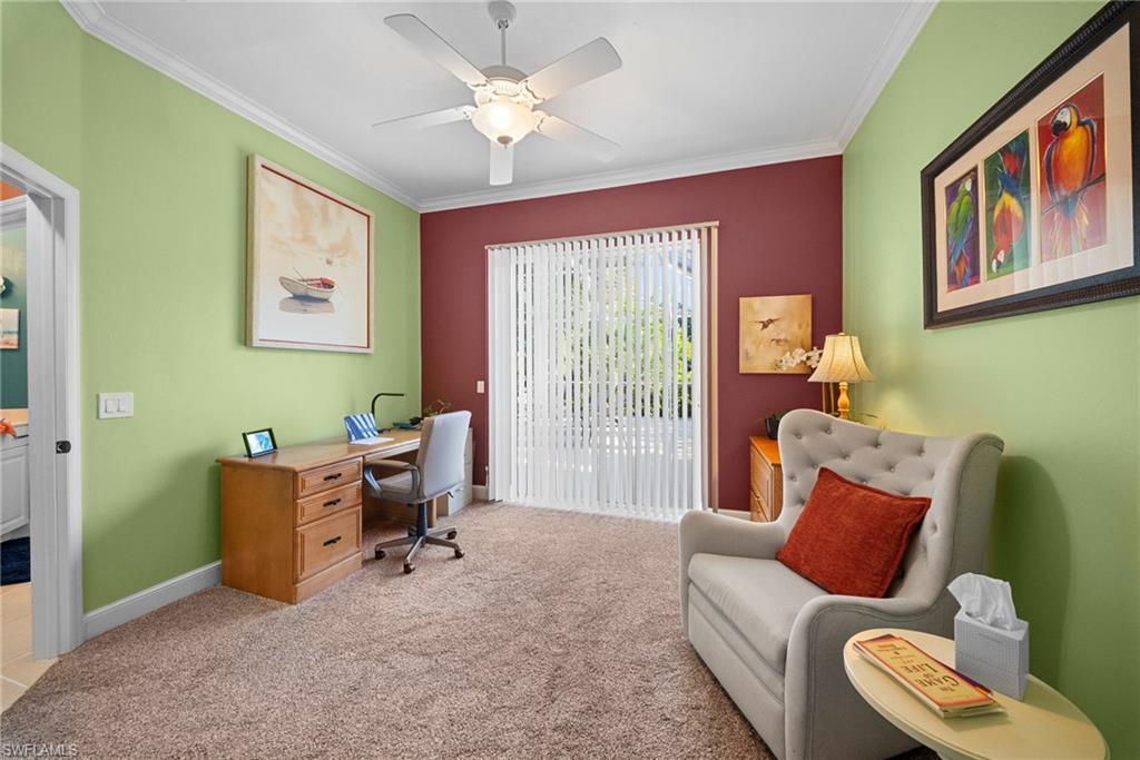 Crown molding, ceiling fan, carpet flooring, vertical blinds, and a sliding glass door