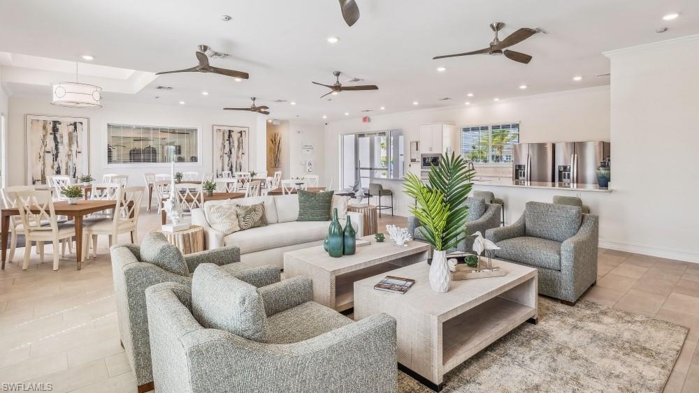 Spacious common area featuring recessed lighting, multiple ceiling fans, tile flooring, and an integrated kitchen with stainless steel appliances
