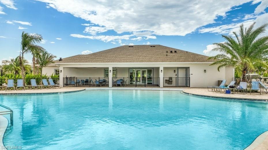 Expansive swimming pool with integrated spa and surrounding paved deck