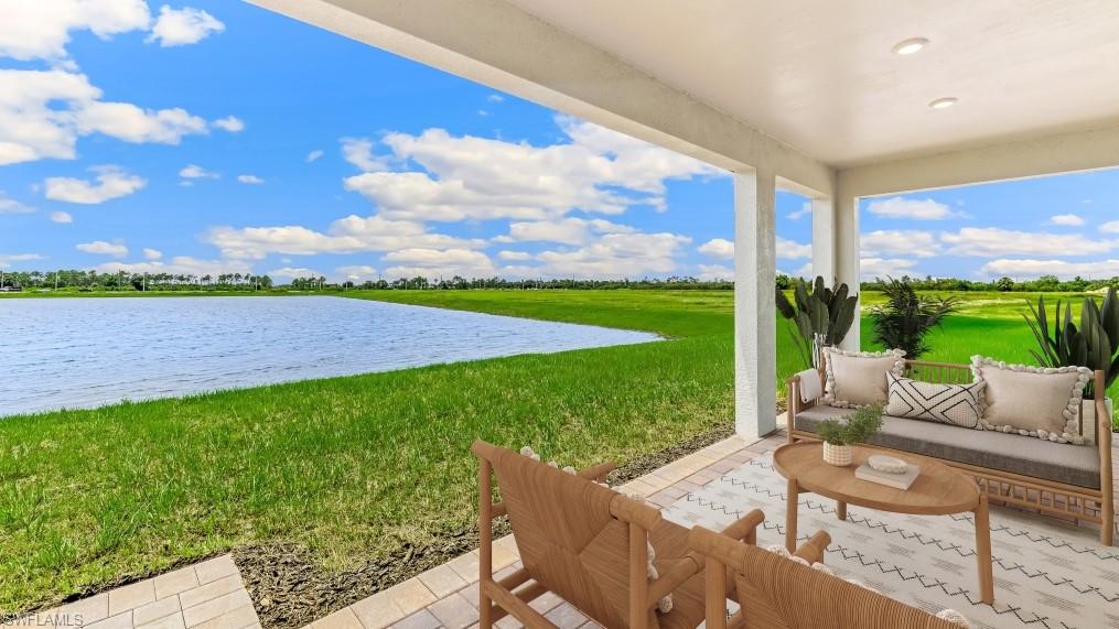 Covered patio with recessed lighting, offering expansive water and green space scenery
