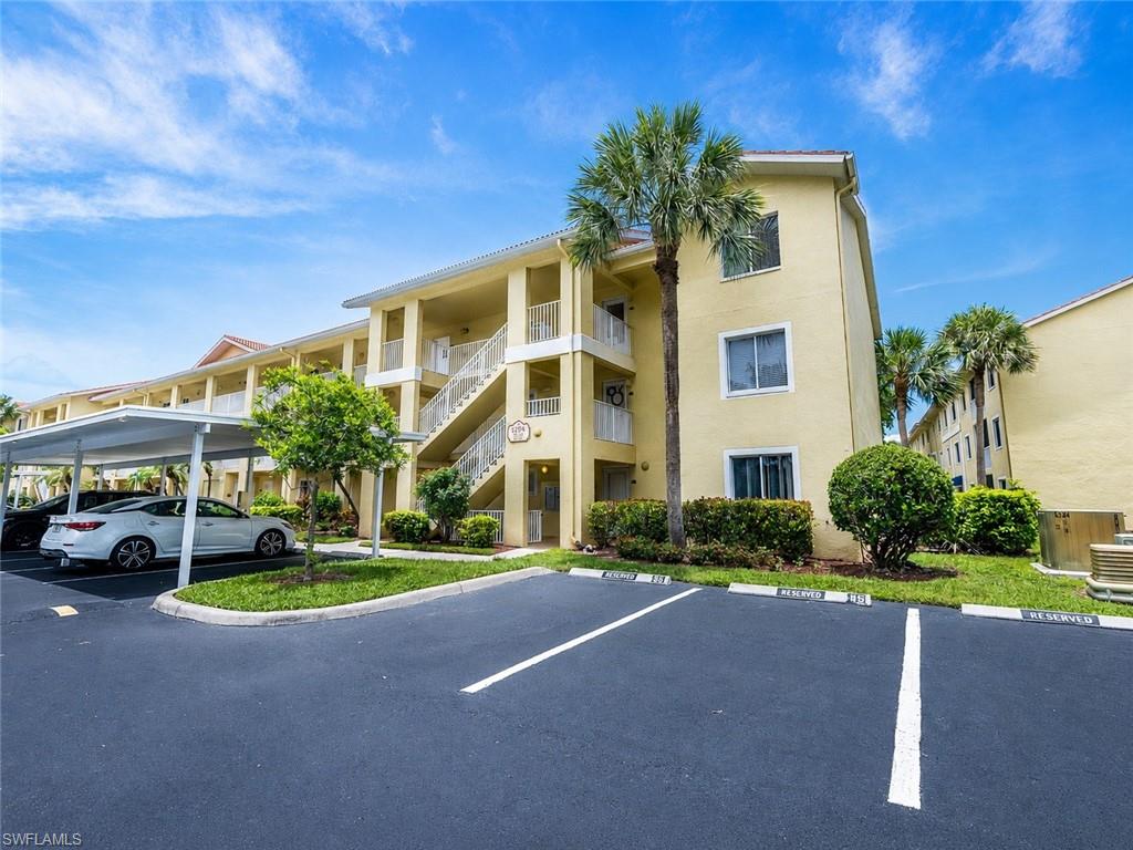 Multi-story residential building featuring a stucco exterior and tiled roof