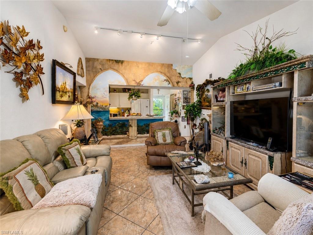 Vaulted ceiling with ceiling fan and track lighting