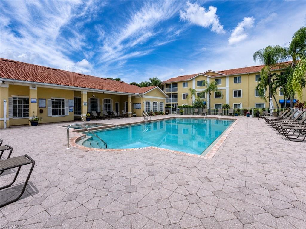 Outdoor swimming pool with integrated spa and surrounding paver deck