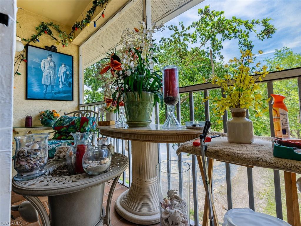 Screened balcony with textured yellow walls and black metal railings