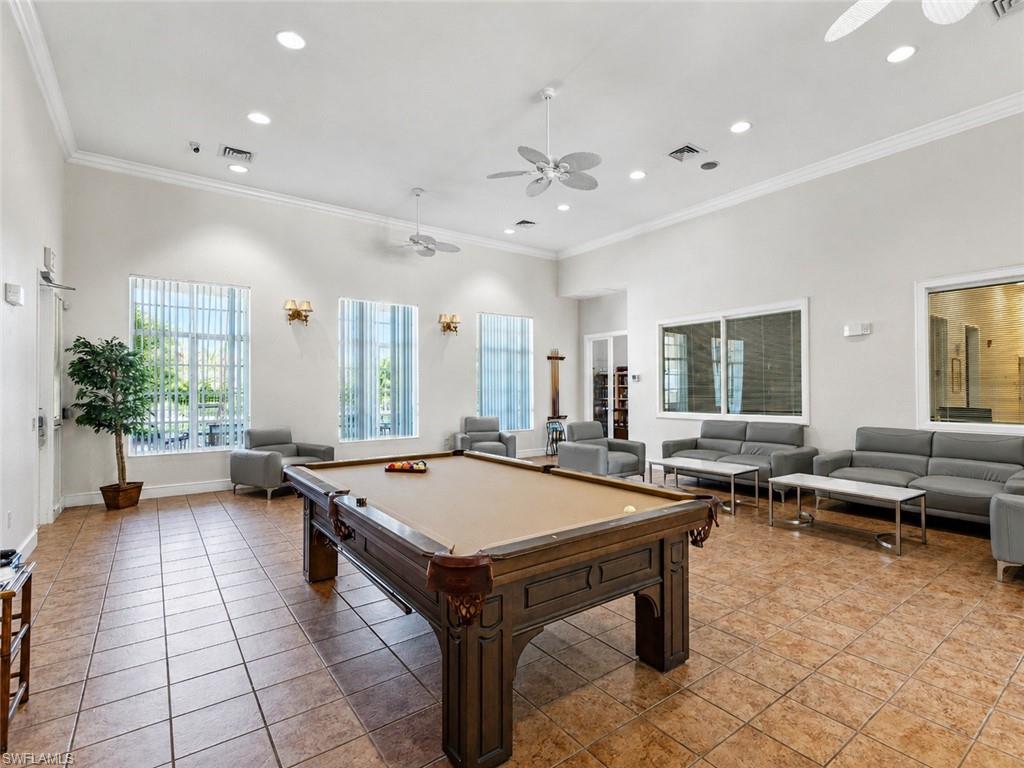Spacious common area featuring a billiards table, tile flooring, recessed lighting, and multiple windows