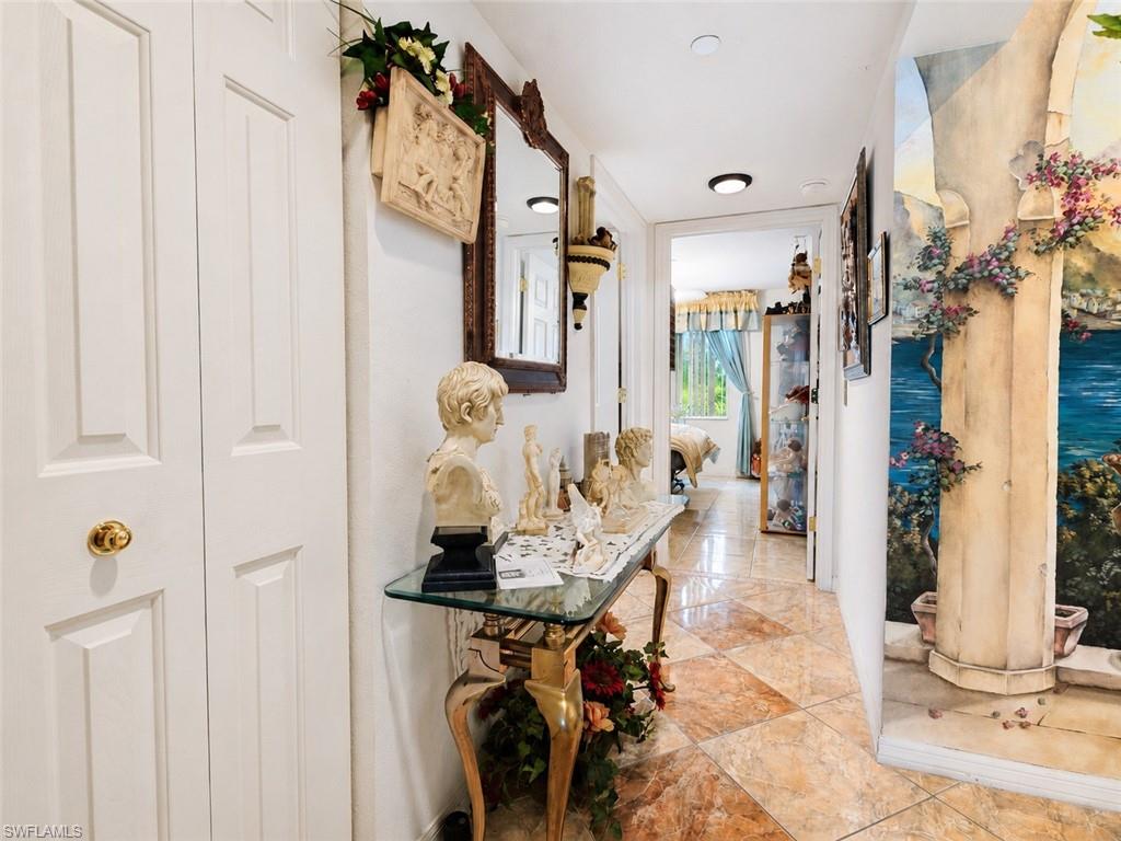Tiled hallway featuring a decorative wall mural