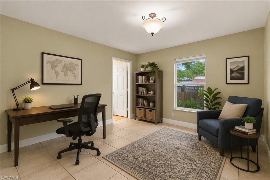 Spacious room with neutral wall tones and large square tile flooring