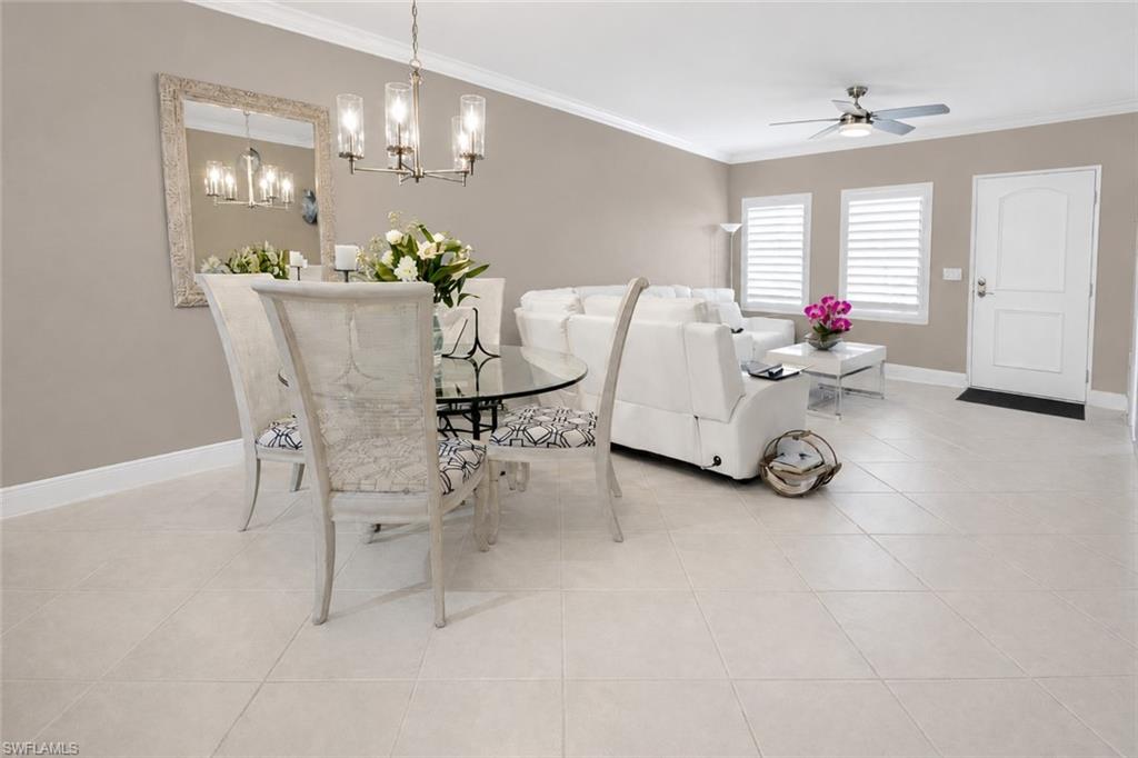 Light-toned tile flooring extends throughout this open-concept living area