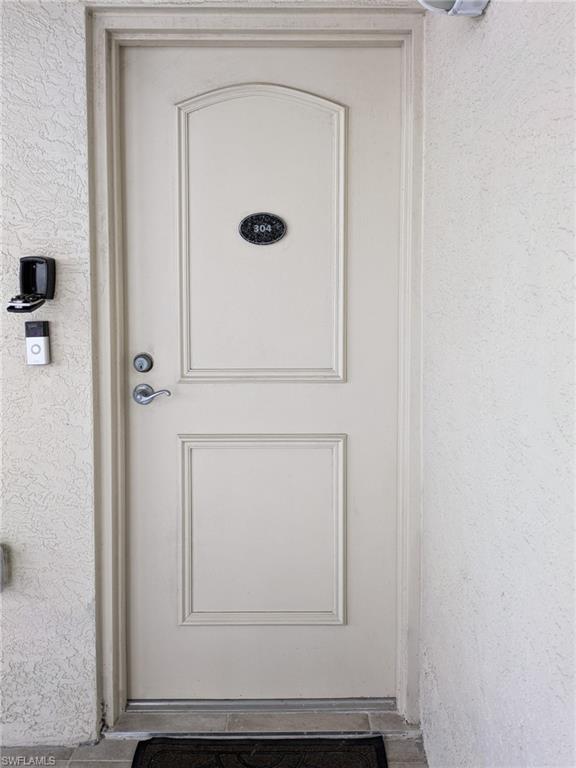 View of exterior entry featuring stucco siding