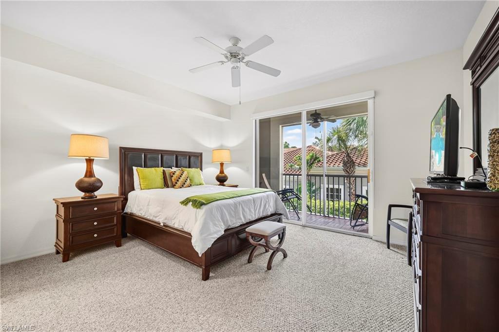 Spacious room with plush carpet flooring and a ceiling fan
