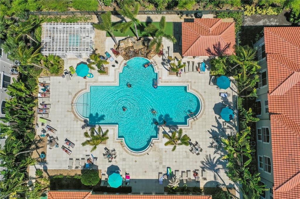 Expansive, clover-shaped pool featuring integrated steps and a rock waterfall feature