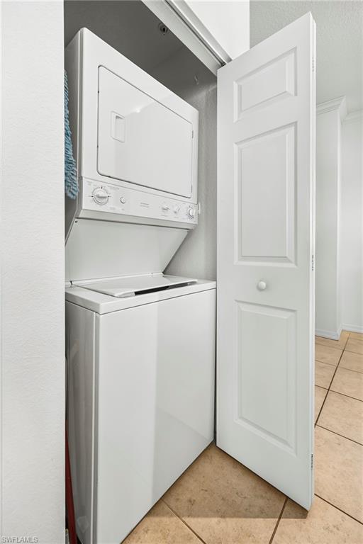 Dedicated laundry closet featuring a white stacked washer and dryer unit